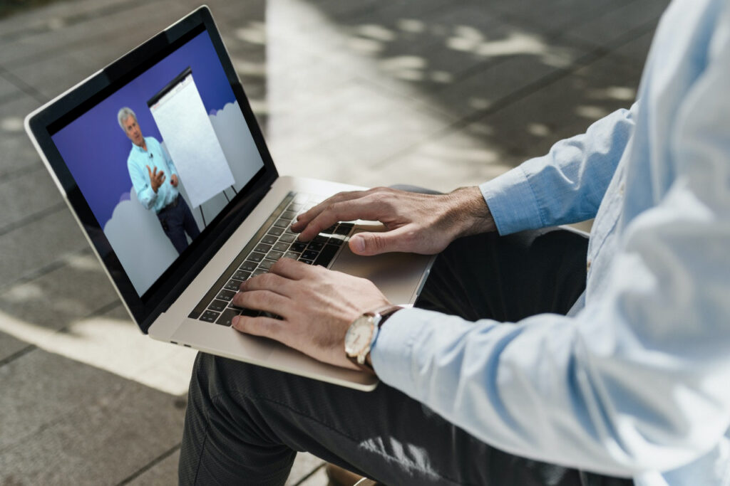 A business man watching a video of Skip Miller teaching the Buy Cycle, as part of the Aspireship SaaS Sales Foundations online couse; Aspireship helps individuals transition into careers in tech sales with the help of their free, on-demand, online SaaS sales training course and job placement program.